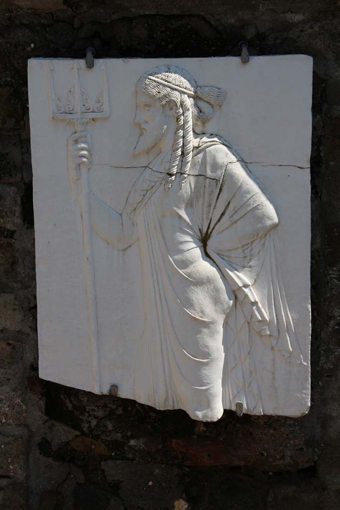 Herculaneum, April 2014. Sacred Area terrace, the shrine of Four Gods. Reproduction relief of Neptune.
Photo courtesy of Klaus Heese.